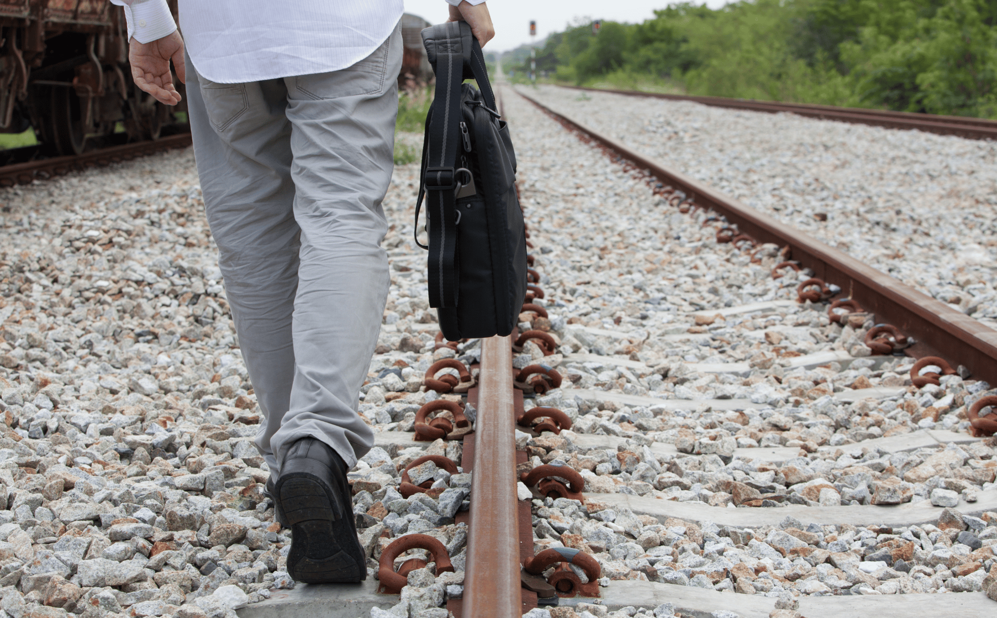 Man Walking Down Railway Tracks